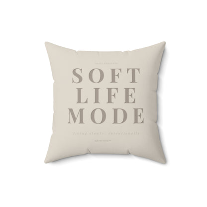 Beige pillow with 'SOFT LIFE MODE' text on a white background