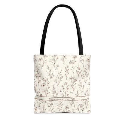 Floral aesthetic tote bag with black cotton handles on clean neutral studio background