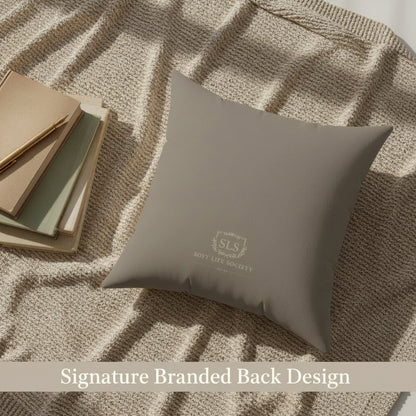 Taupe brown pillow with a brand logo on a textured surface