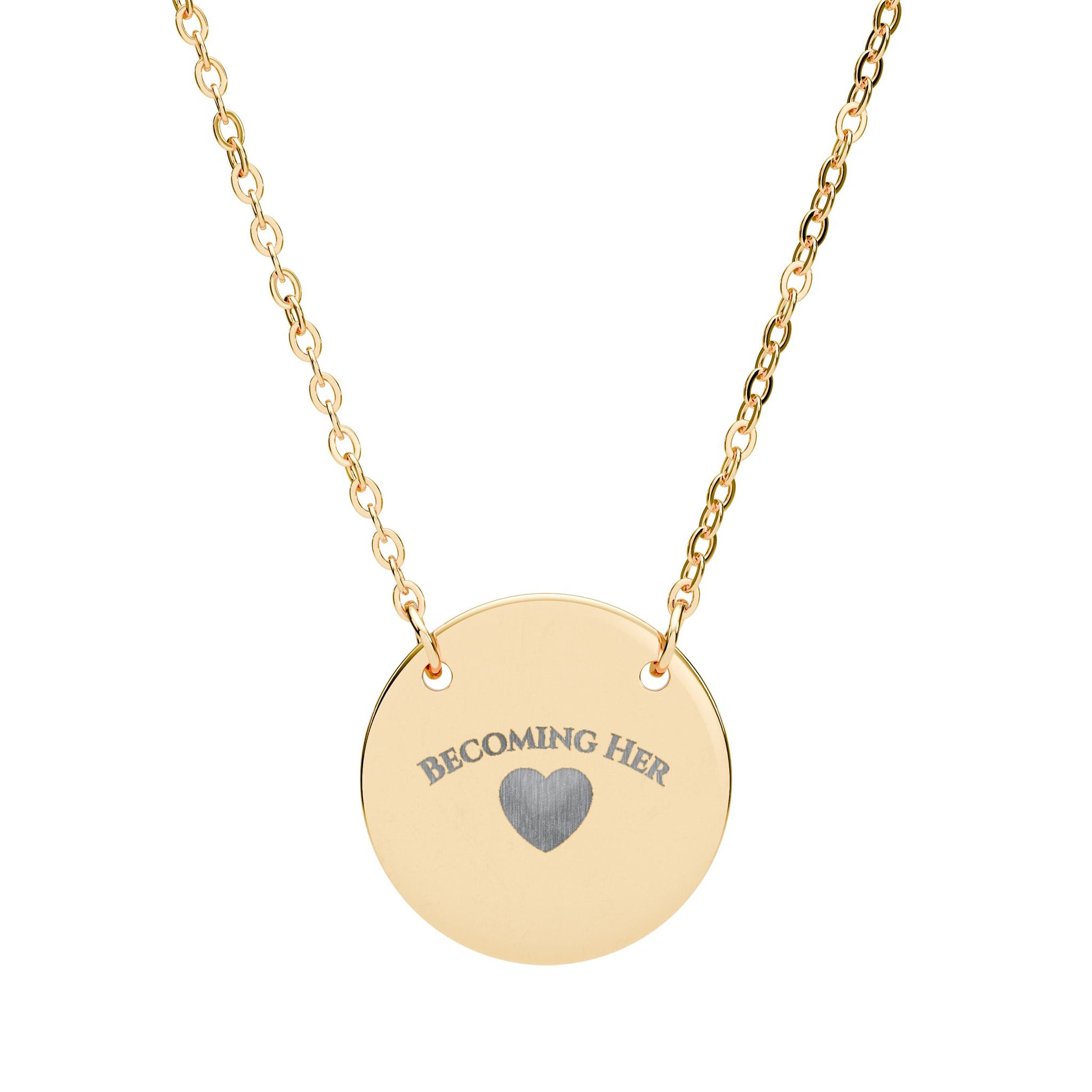 Gold necklace with a round pendant engraved with 'Becoming Her' and a heart symbol on a white background.