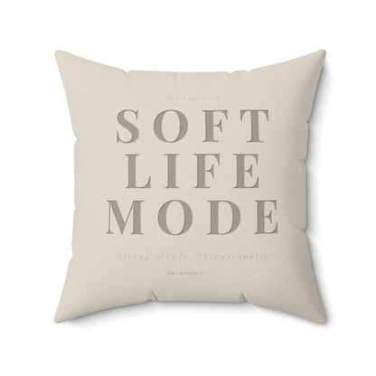 Beige pillow with 'SOFT LIFE MODE' text on a white background