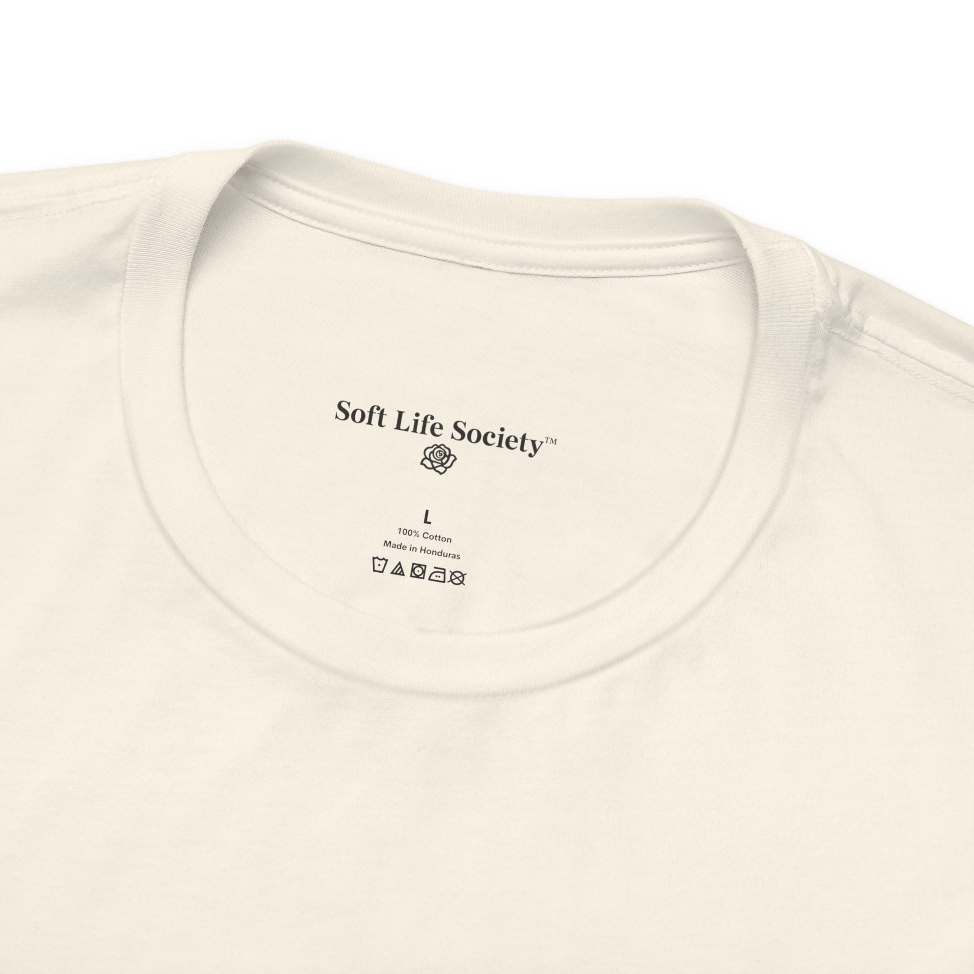 Close-up of a beige t-shirt with branding text on the collar area.
