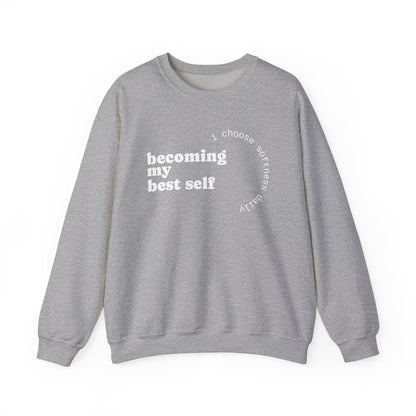 Heather grey sweatshirt displayed flat with “becoming my best self” circular softness quote design.