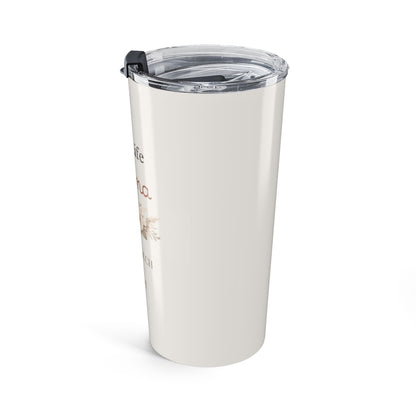 Angled view of white tumbler with text and a design on a white background