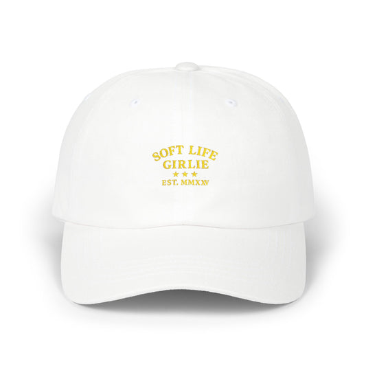 White Soft Life Girlie™ dad hat with yellow embroidered text on a white background.