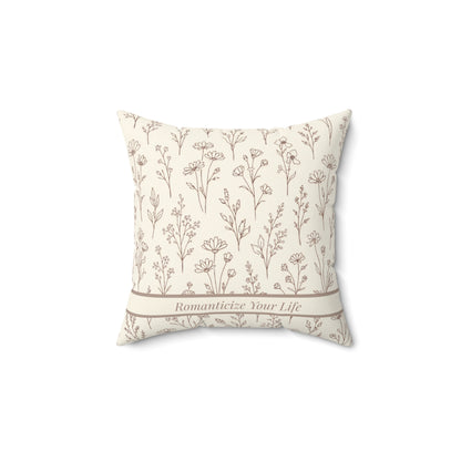 Decorative pillow with floral pattern and text on a white background