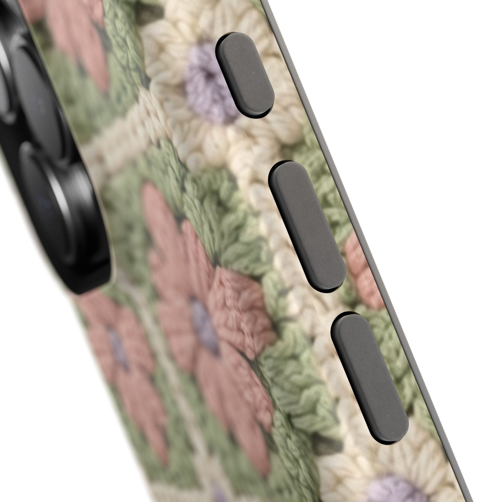 Close-up of a phone case with floral design and black buttons
