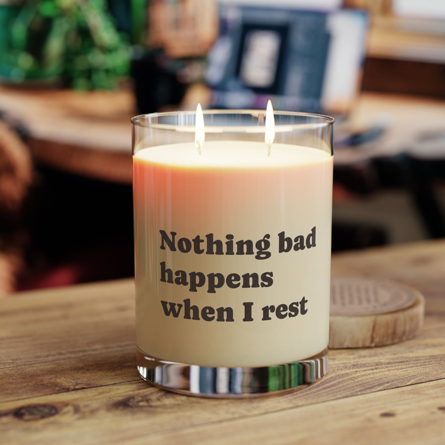 Soft Life Society Affirmation Candle with 'Nothing bad happens when I rest' text on a wooden surface