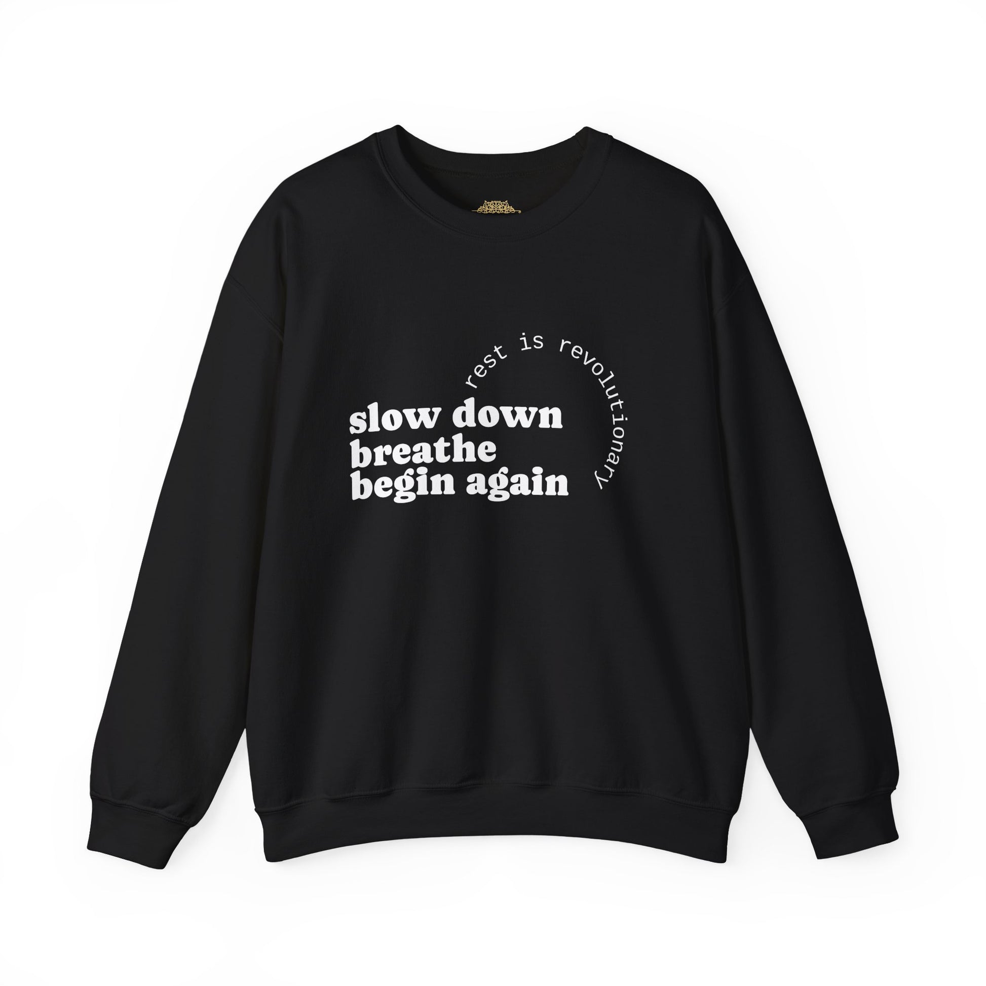 Black crewneck sweatshirt with white printed text reading ‘slow down breathe begin again’ and ‘rest is revolutionary’ in a circular layout.