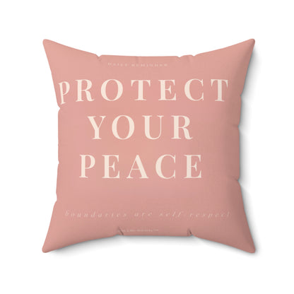 Pink pillow with 'Protect Your Peace' text on a white background