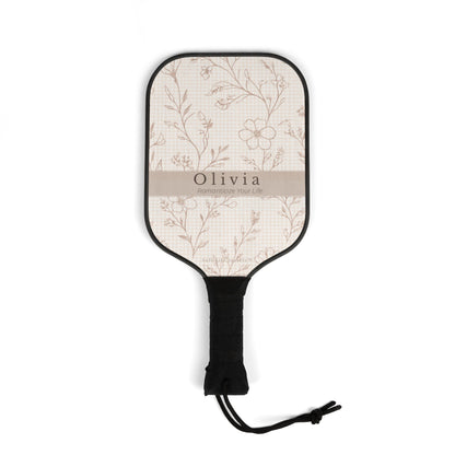 Floral-patterned paddle with 'Olivia' branding on a white background
