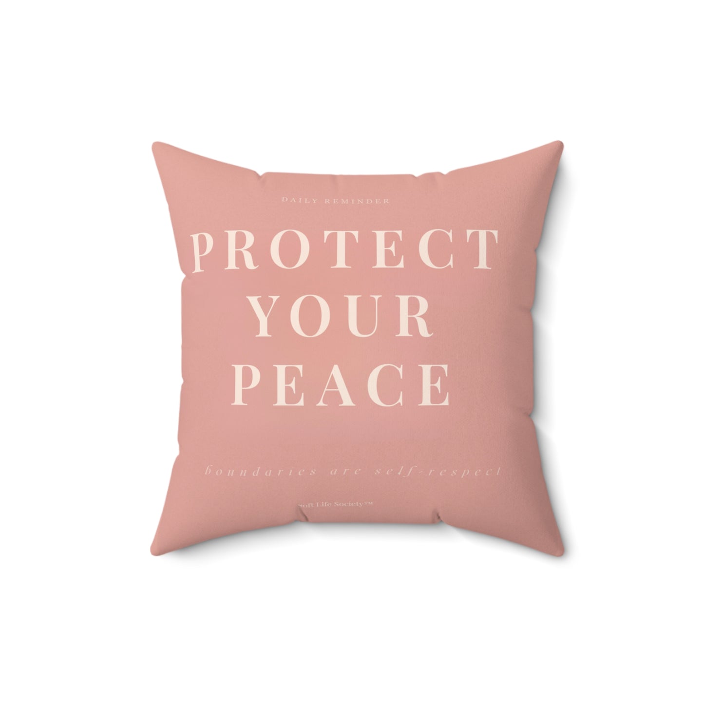 Pink pillow with 'Protect Your Peace' text on a white background