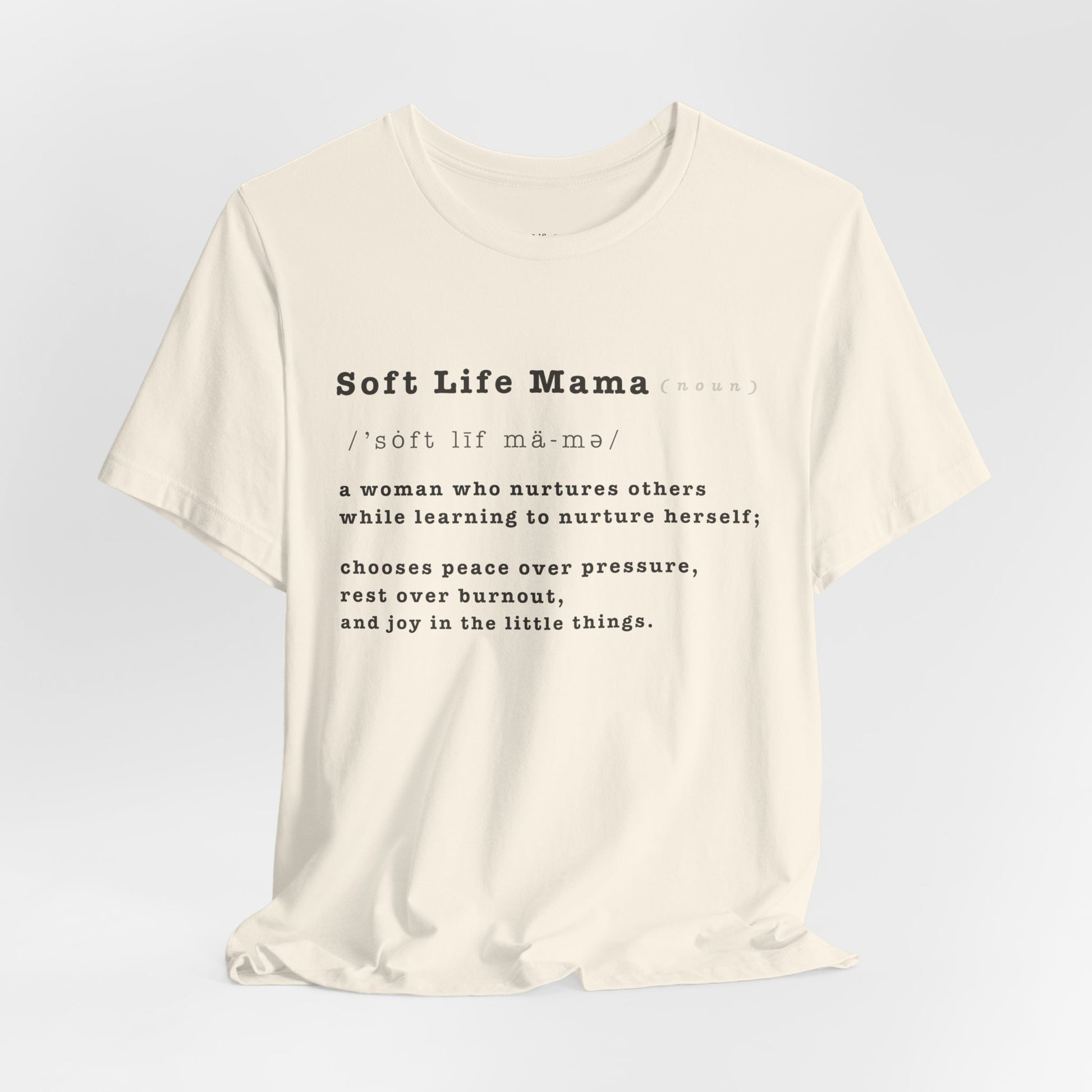 White t-shirt with 'Soft Life Mama' text on a light gray background