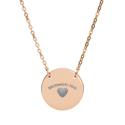 Rose gold necklace with a round pendant engraved with 'Becoming Her' and a heart symbol on a white background.