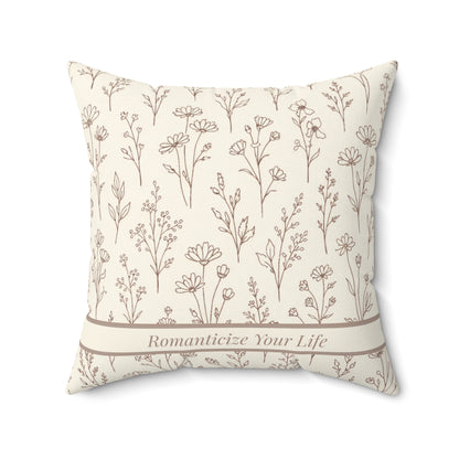 Decorative pillow with floral pattern and text on a white background