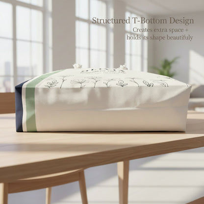 Bottom view of t-bottom weekender tote with green stripe and floral design on a white background