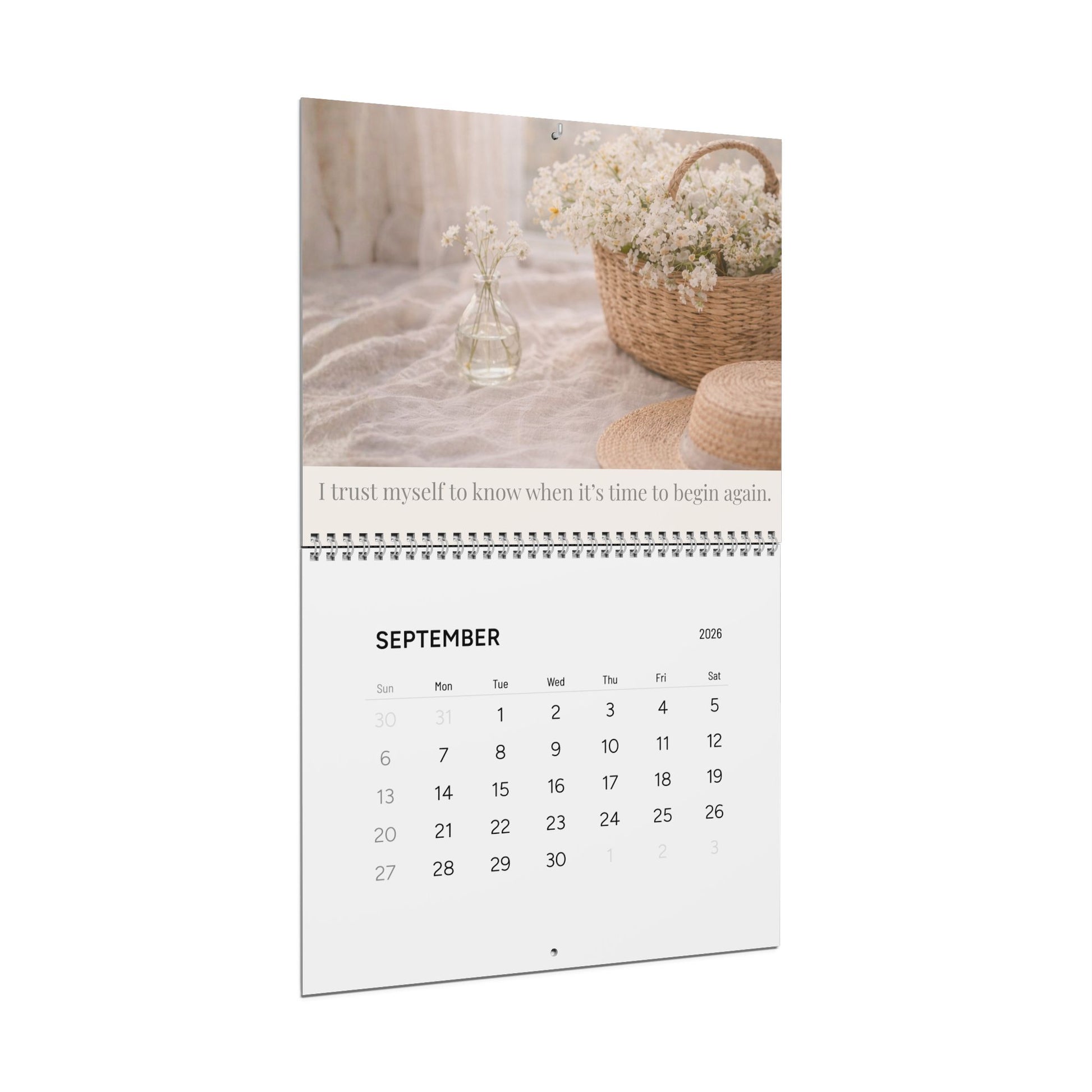 Calendar with September 2026 display featuring a basket of flowers and text on a white background