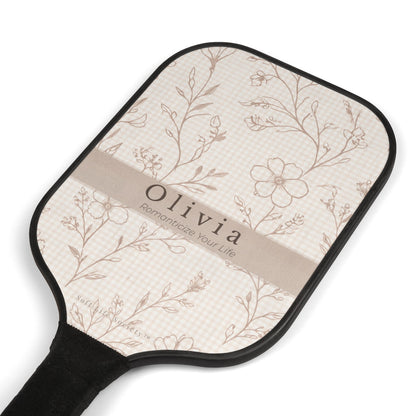 Paddle with floral pattern and 'Olivia' branding on a white background