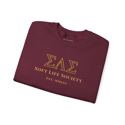 Folded maroon sweatshirt with gold text and logo on a white background
