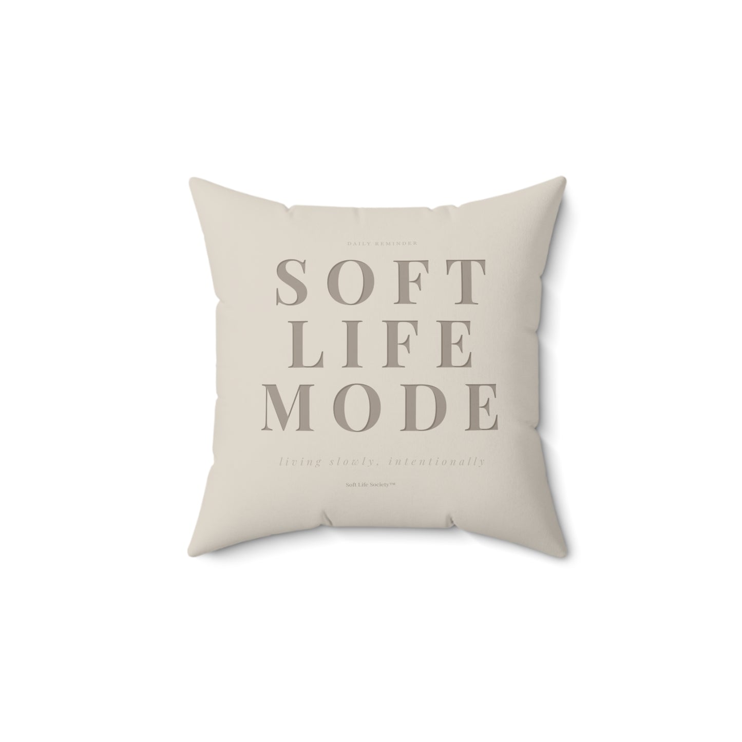 Beige pillow with 'SOFT LIFE MODE' text on a white background