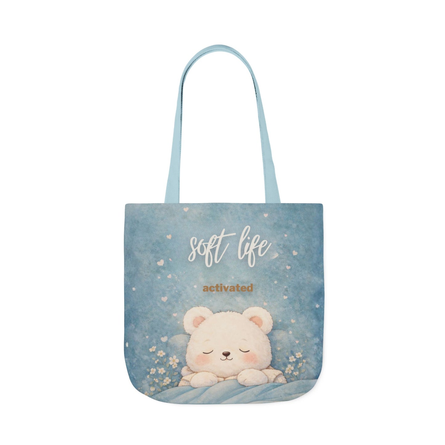 Tote bag with a bear design and 'soft life activated' text on a blue background