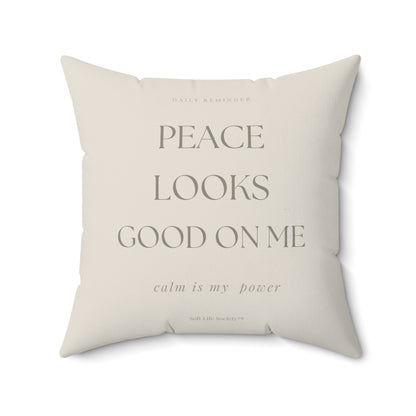 Beige pillow with motivational text on a white background