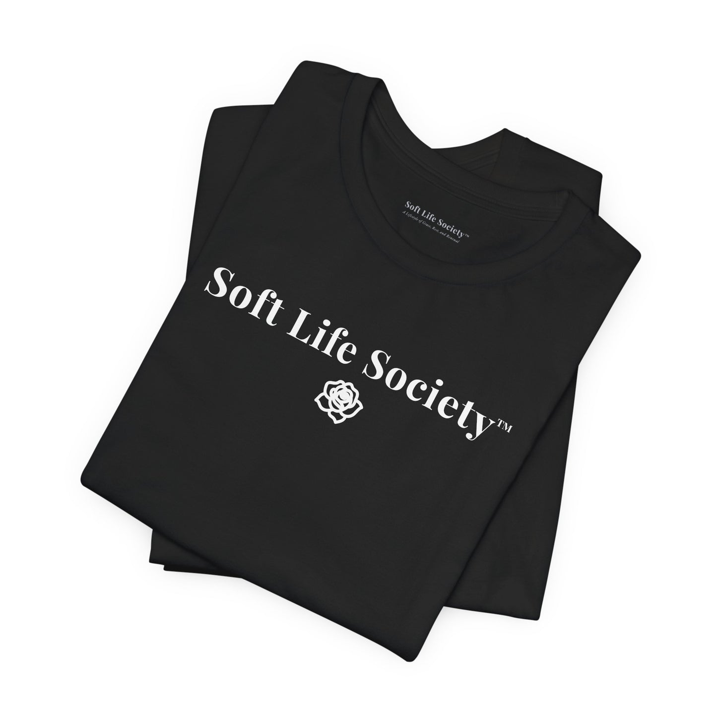 Folded black Soft Life Society t-shirt with white logo, minimalist cotton tee close up