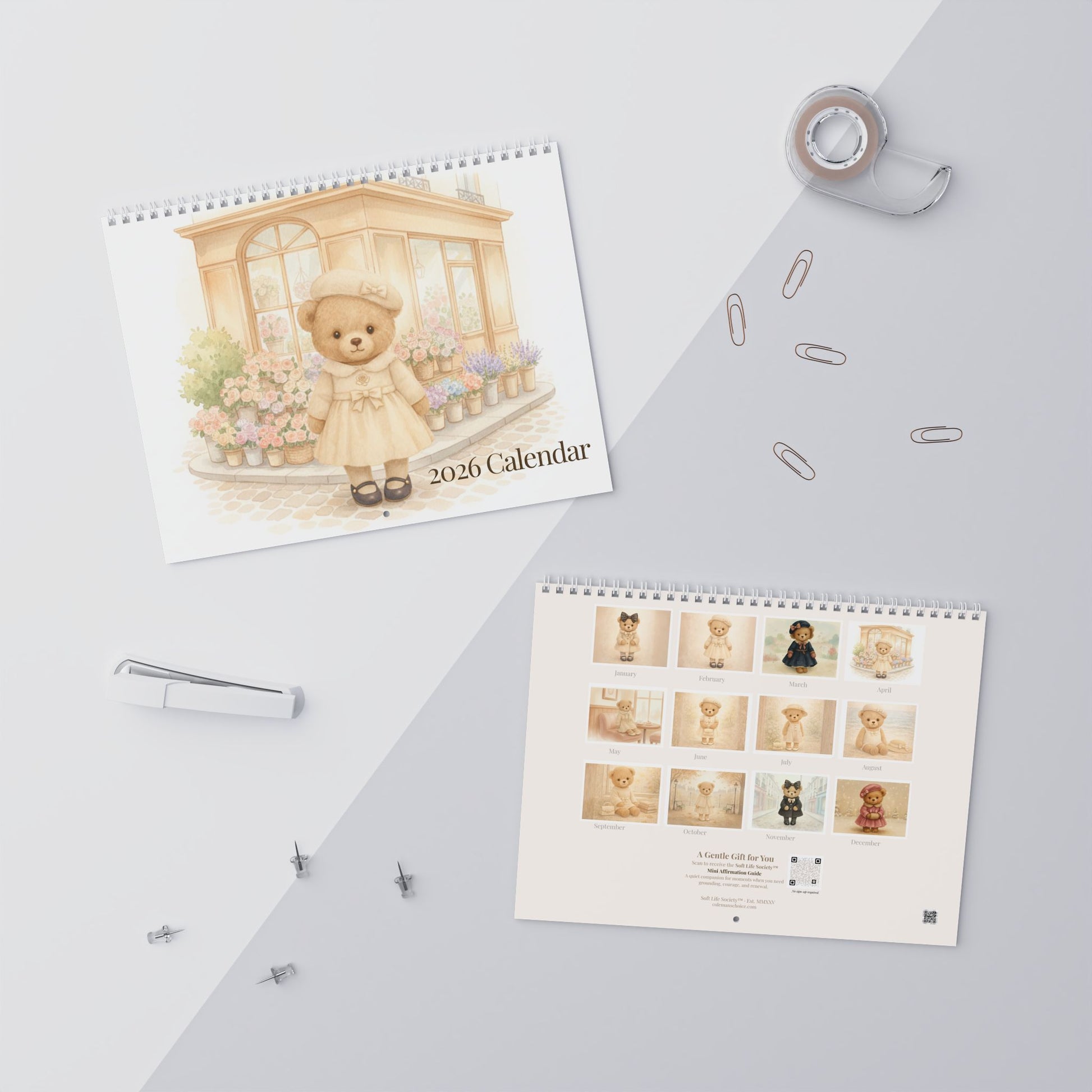 Two calendars featuring teddy bear illustrations on a light gray surface with office supplies.