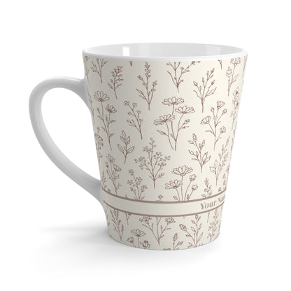 Side view of neutral botanical ceramic latte mug highlighting curved handle shape and wraparound floral pattern.