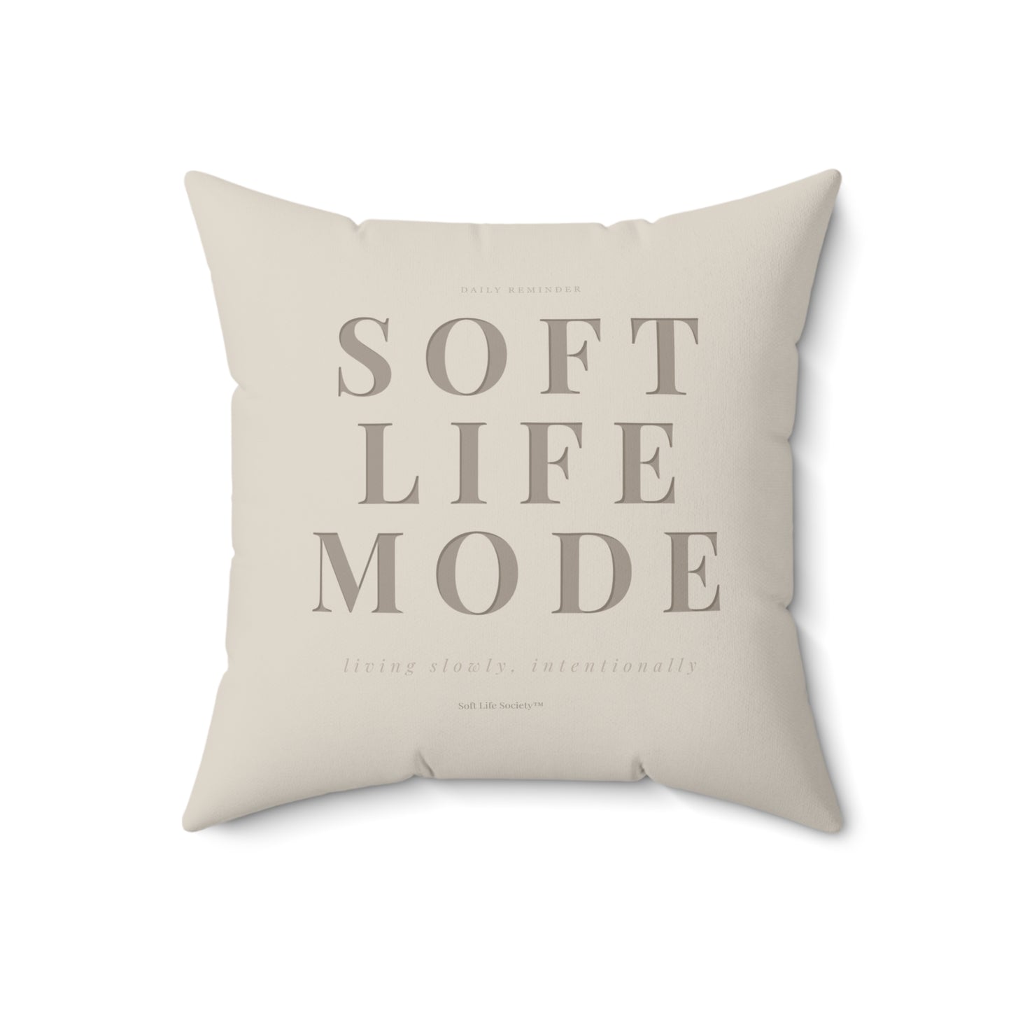 Beige pillow with 'SOFT LIFE MODE' text on a white background