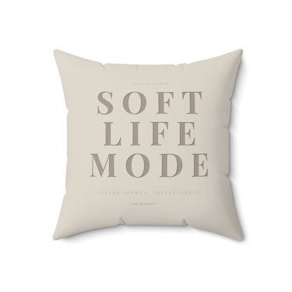 Beige pillow with 'SOFT LIFE MODE' text on a white background