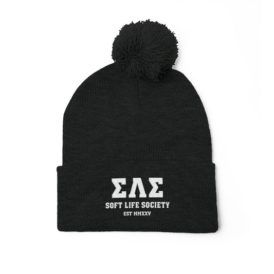 Black beanie with pom-pom and 'Soft Life Society' text on a white background