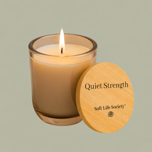 Candle with wooden lid labeled 'Quiet Strength' from Soft Life Society on a light green background