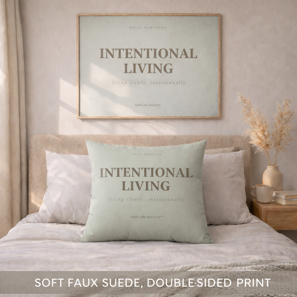 Bedroom with 'Intentional Living' pillow and framed artwork on the wall.