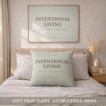 Bedroom with 'Intentional Living' pillow and framed artwork on the wall.