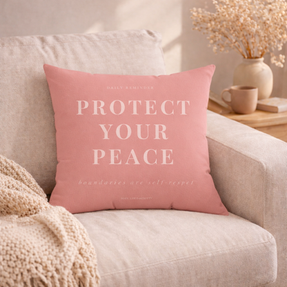 Pink pillow with 'Protect Your Peace' text on a beige couch