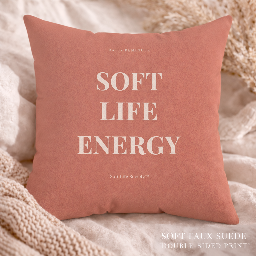 Pink pillow with 'Soft Life Energy' text on a soft background