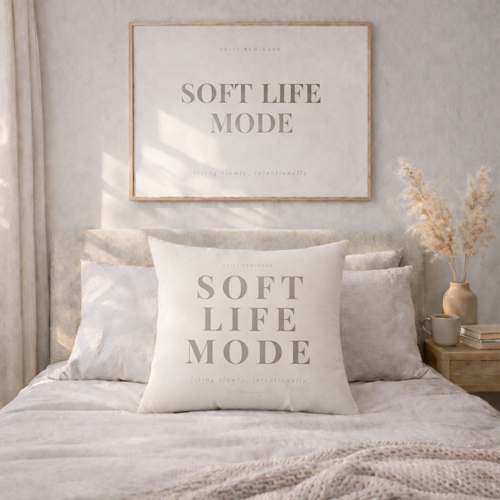 Bedroom with 'Soft Life Mode' pillow and framed artwork on the wall.