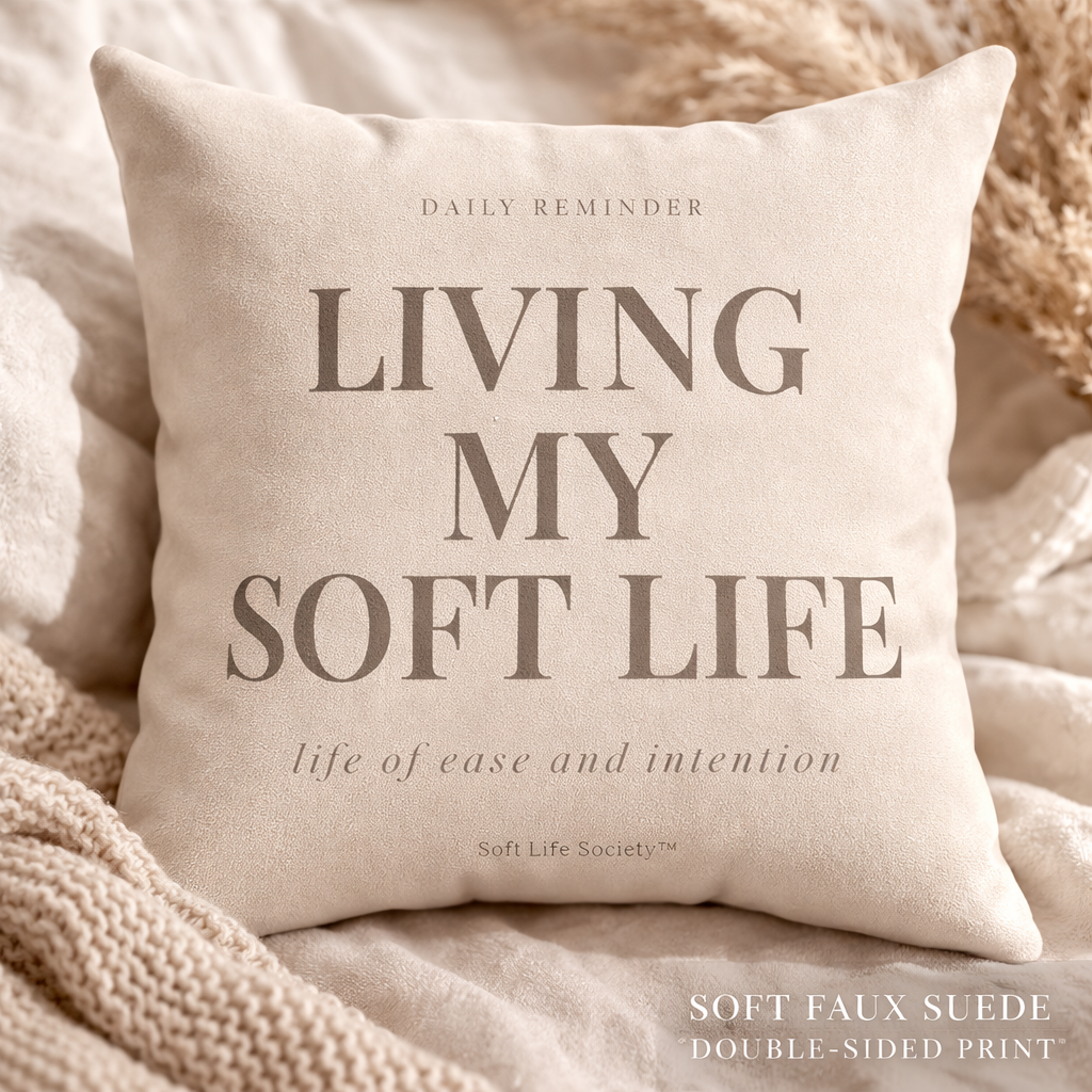 Beige pillow with 'Living My Soft Life' text on a soft background