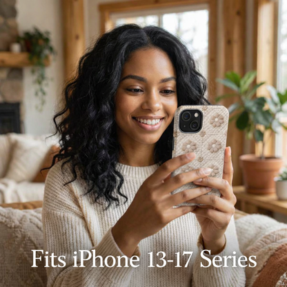 Woman holding a phone with a floral case in a cozy living room.