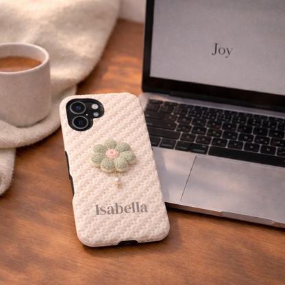 Phone case with floral design and 'Isabella' branding on a wooden desk with laptop and coffee.