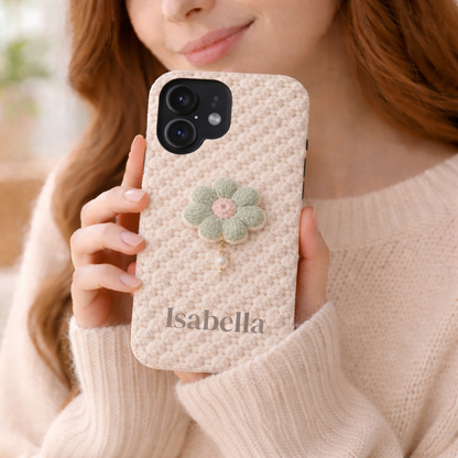 Person holding a textured phone case with a floral design and 'Isabella' branding.