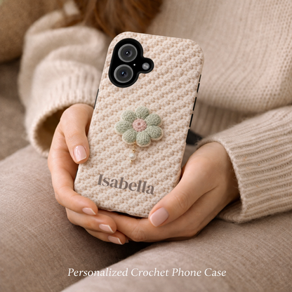 Person holding a personalized crochet phone case with a floral design and 'Isabella' branding.