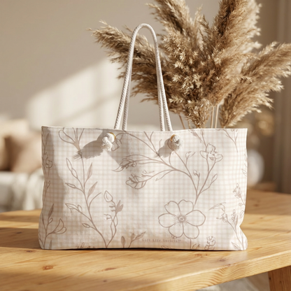 Floral-patterned tote bag with dried pampas grass on a wooden surface