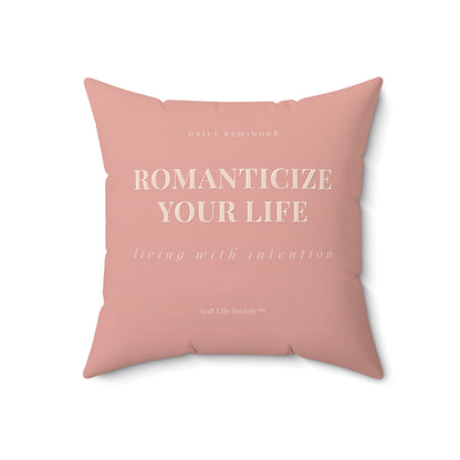 Pink pillow with motivational text on a white background