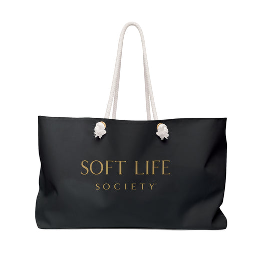 Black tote bag with 'SOFT LIFE SOCIETY' text on a white background