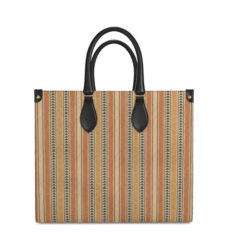 A stylish woman in a cream tailored suit stands in a bright, modern living room, holding the Solara Stripe Microprint™ Nappa Leather Shopper Bag by Soft Life Society™.