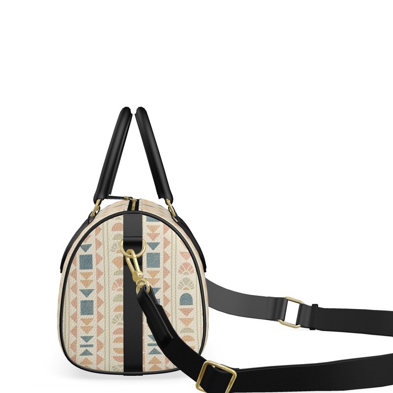 Sideview of round leather mini duffle with geometric pattern and black strap on a white background