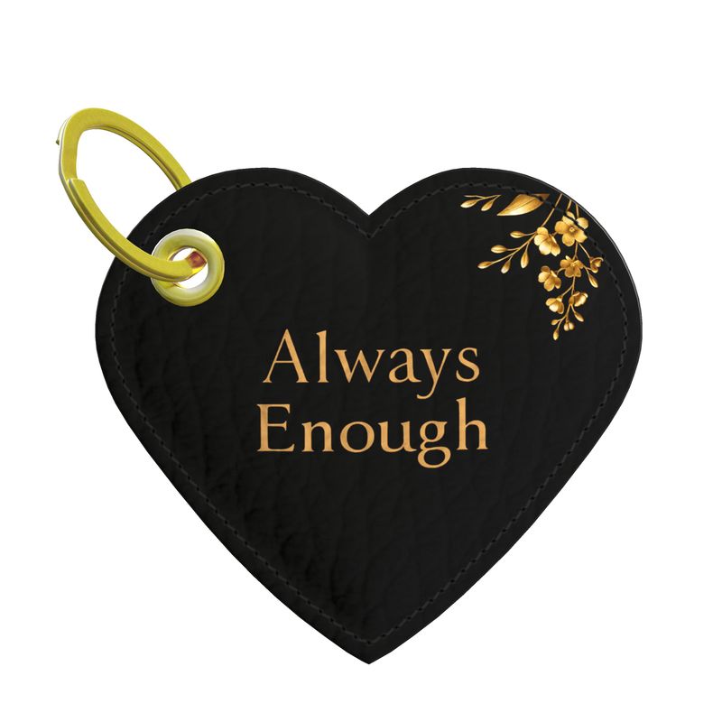 Black heart-shaped keychain with 'Always Enough' text and gold accents on a white background