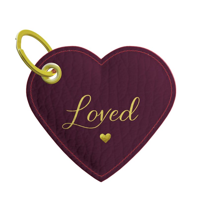 Heart-shaped keychain with 'Loved' text and gold heart on a white background